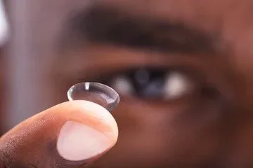 Contact lens resting on a fingertip